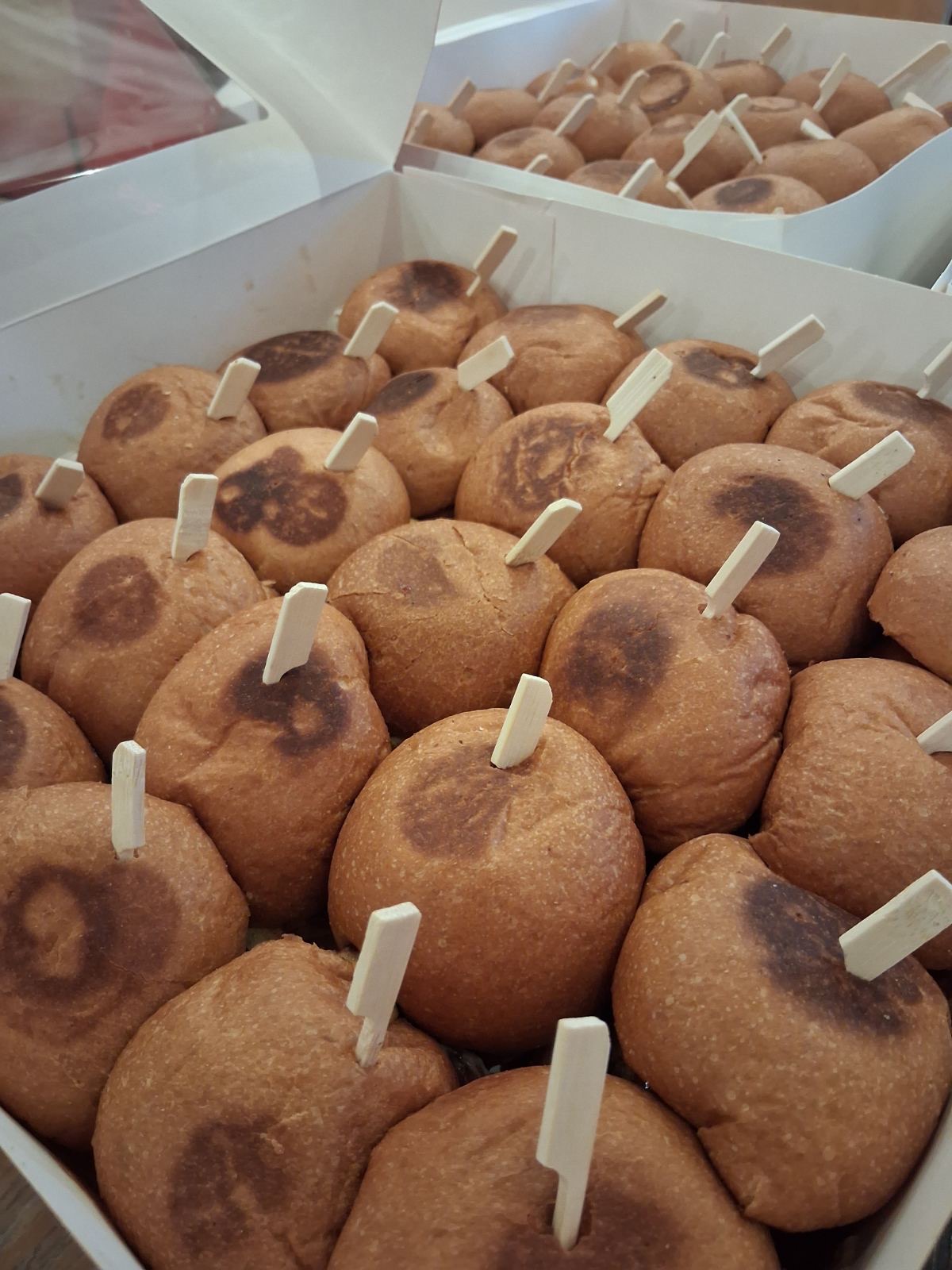 Fresh mini burger buns ready for catering
